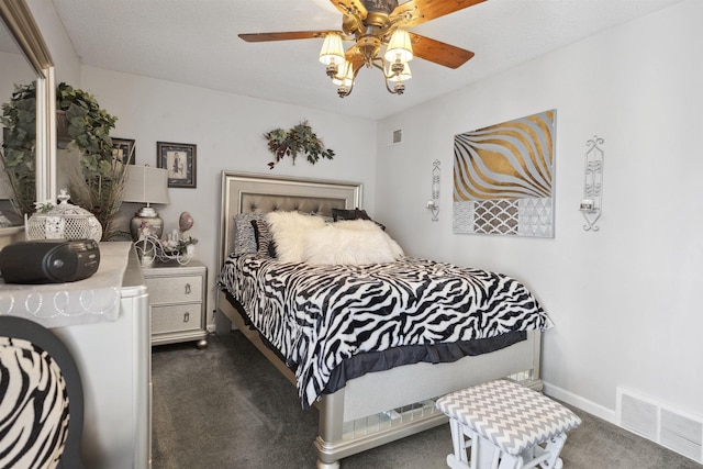 bedroom with ceiling fan and dark colored carpet