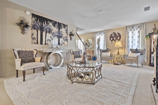 living room featuring light carpet, a healthy amount of sunlight, and a textured ceiling