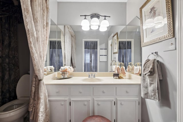 bathroom featuring toilet and vanity