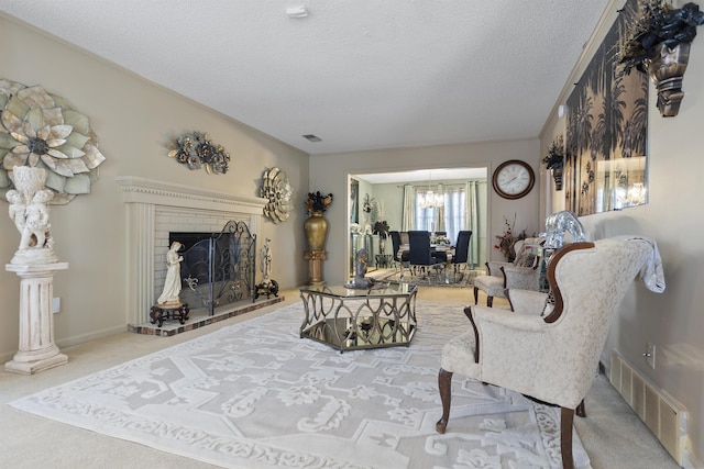 living room with a textured ceiling, a fireplace, and carpet floors