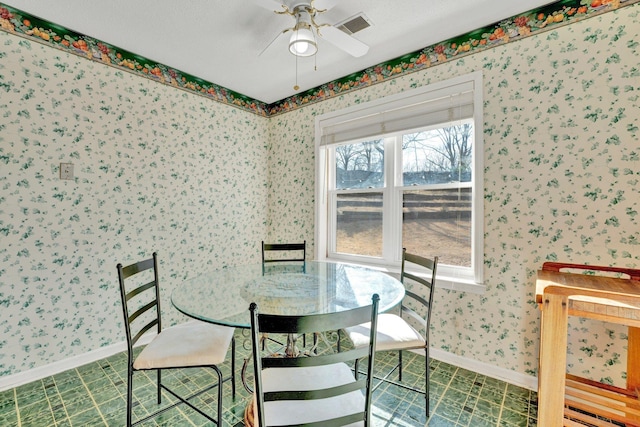 tiled dining area featuring ceiling fan