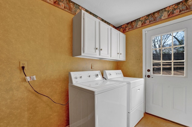 laundry area featuring cabinets and washing machine and clothes dryer