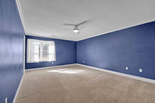 carpeted empty room with a textured ceiling, ceiling fan, and ornamental molding