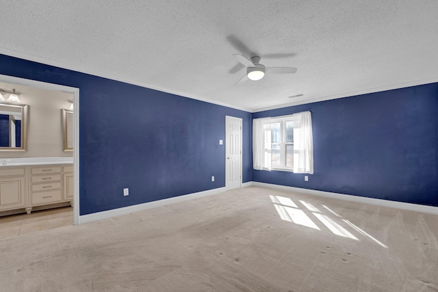 unfurnished bedroom with ceiling fan, ensuite bathroom, and light carpet