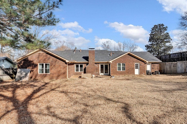 rear view of property featuring a yard