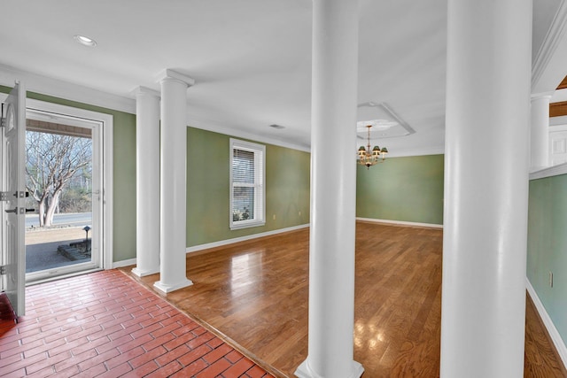 interior space featuring ornate columns, an inviting chandelier, and crown molding