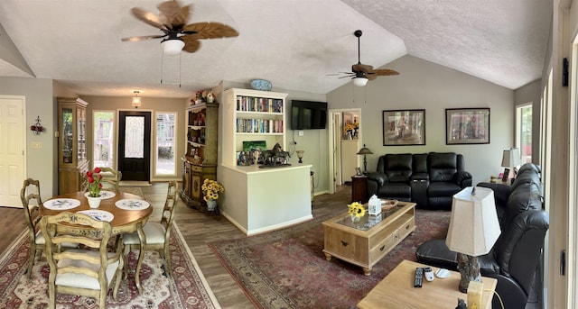 living room featuring ceiling fan, a textured ceiling, dark hardwood / wood-style flooring, and lofted ceiling