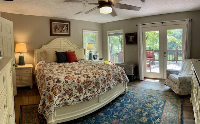 bedroom featuring ceiling fan, dark wood-type flooring, multiple windows, and access to outside