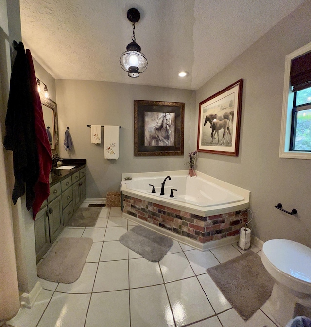 bathroom with tile patterned floors, toilet, a textured ceiling, vanity, and a washtub