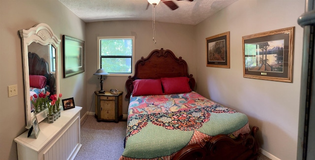 bedroom featuring ceiling fan, a textured ceiling, and carpet flooring