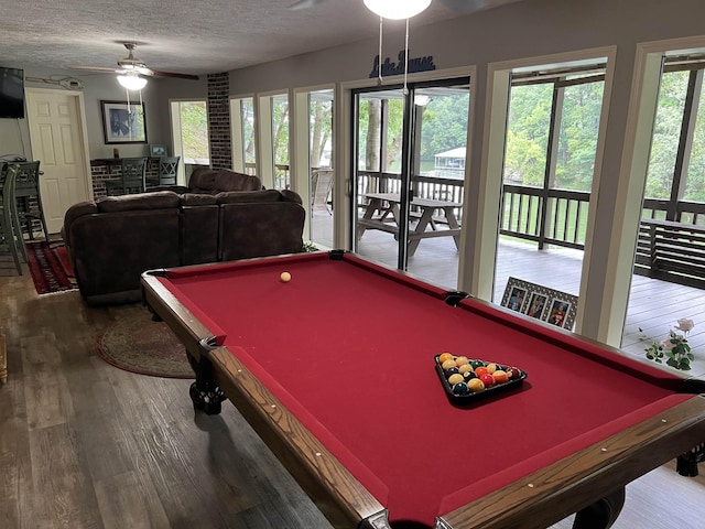 game room with wood-type flooring, plenty of natural light, a textured ceiling, and billiards