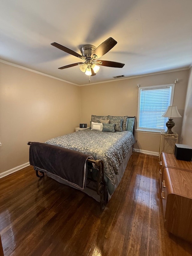 bedroom featuring dark wood-type flooring, ceiling fan, and ornamental molding