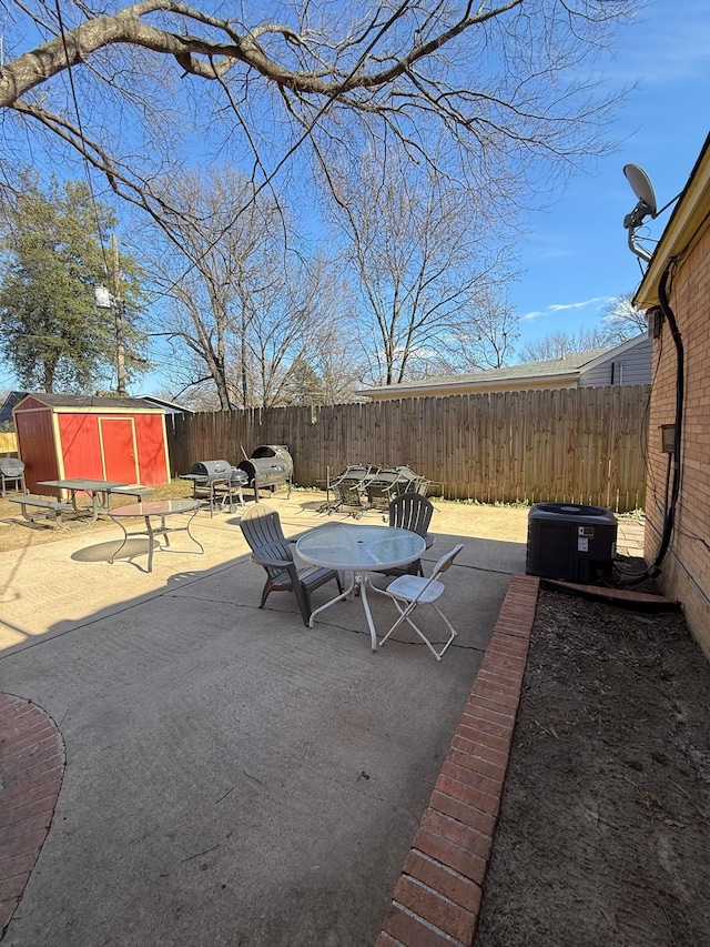 view of patio / terrace with central AC unit and a storage shed