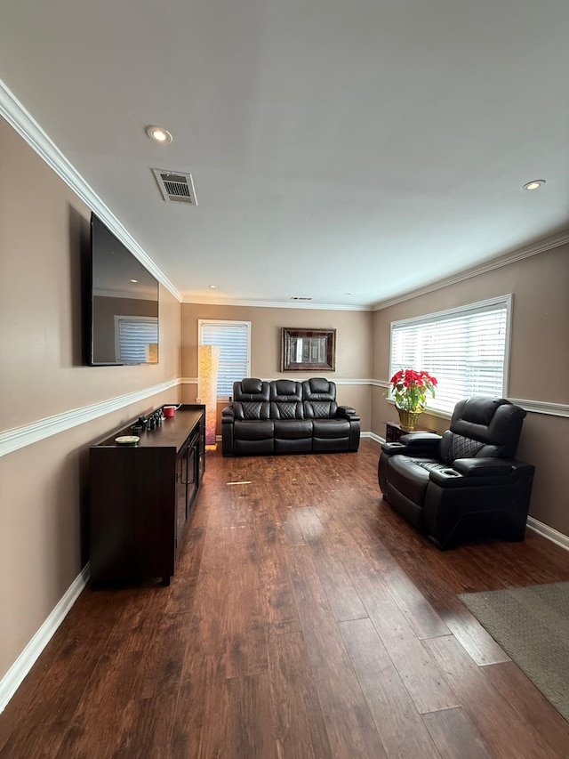 living room with dark wood-type flooring and ornamental molding