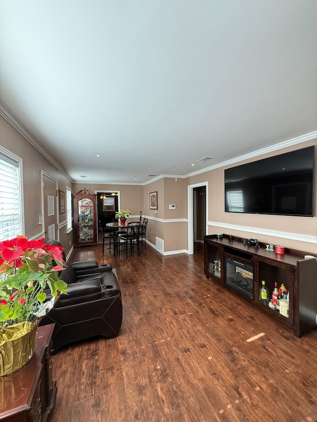 living room with crown molding and hardwood / wood-style floors