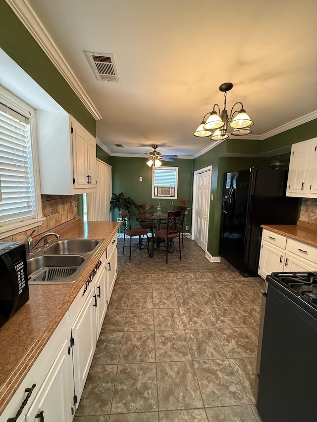 kitchen with pendant lighting, sink, white cabinetry, and tasteful backsplash