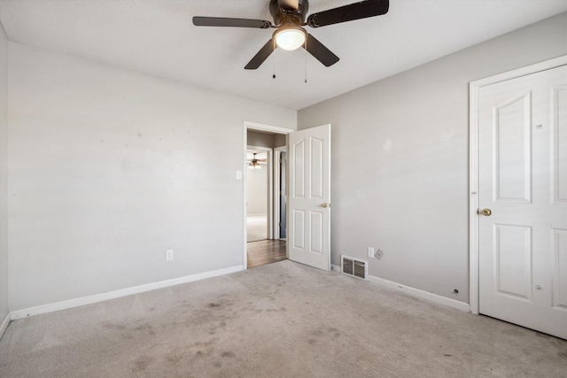 unfurnished bedroom with ceiling fan and light carpet