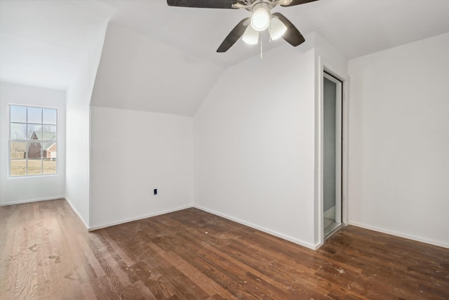 bonus room with vaulted ceiling and dark hardwood / wood-style flooring