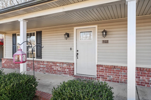 view of exterior entry with covered porch