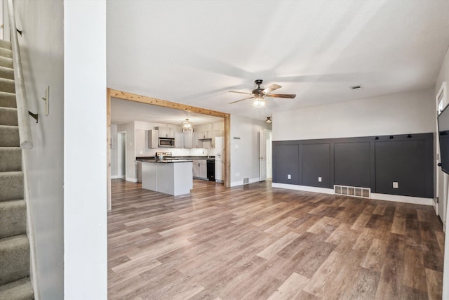 unfurnished living room featuring light hardwood / wood-style floors and ceiling fan