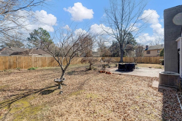 view of yard with central AC unit and a patio