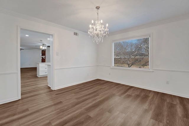 unfurnished dining area featuring ornamental molding, an inviting chandelier, and wood-type flooring