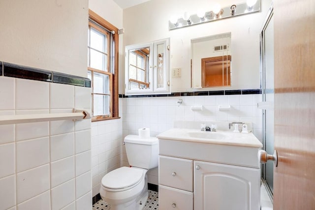 bathroom featuring tile walls, tile patterned floors, vanity, and toilet