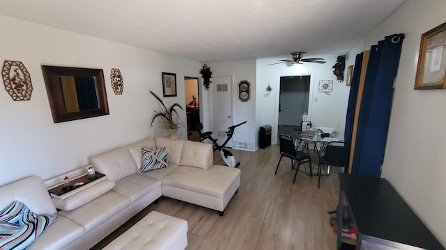 living room featuring ceiling fan and light hardwood / wood-style flooring