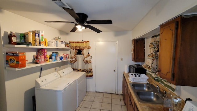 laundry area with sink, ceiling fan, light tile patterned flooring, and independent washer and dryer