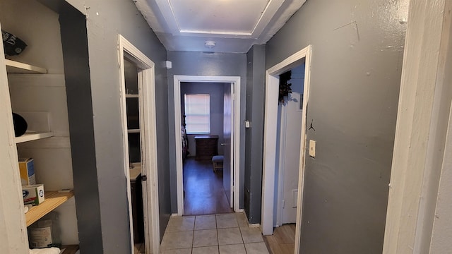 hall with light tile patterned floors