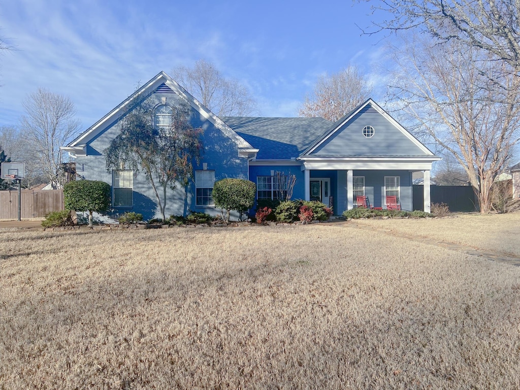 view of front of home featuring covered porch and a front yard