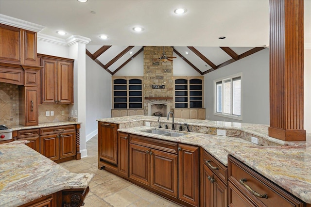 kitchen featuring tasteful backsplash, ceiling fan, sink, vaulted ceiling with beams, and light stone counters