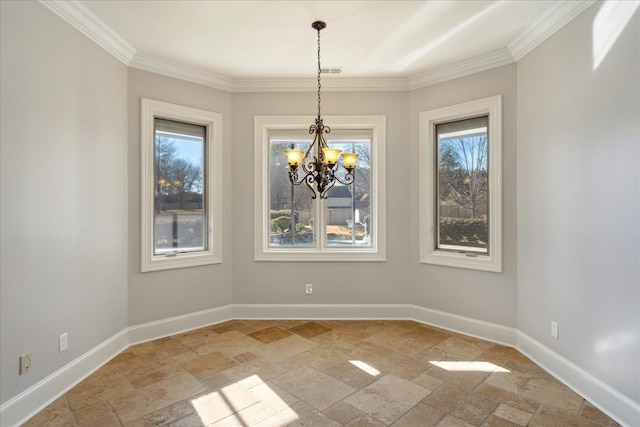 unfurnished dining area with a healthy amount of sunlight, an inviting chandelier, and crown molding