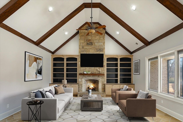 living room featuring ceiling fan, a stone fireplace, beamed ceiling, and high vaulted ceiling