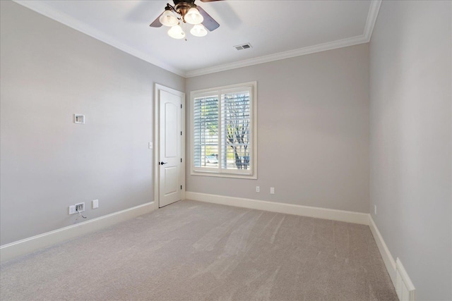 spare room with ceiling fan, light colored carpet, and ornamental molding