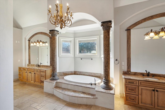 bathroom featuring a bath, vanity, ornamental molding, decorative columns, and a chandelier