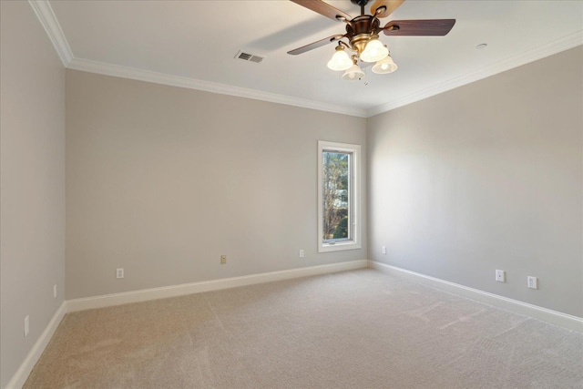 carpeted spare room featuring ceiling fan and ornamental molding