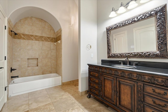 bathroom featuring vanity and tiled shower / bath