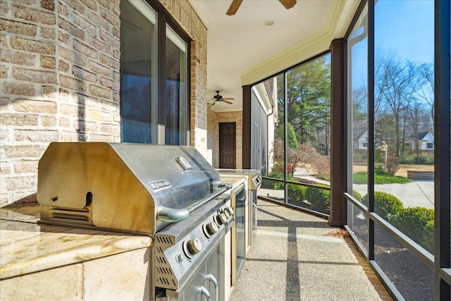 sunroom featuring ceiling fan