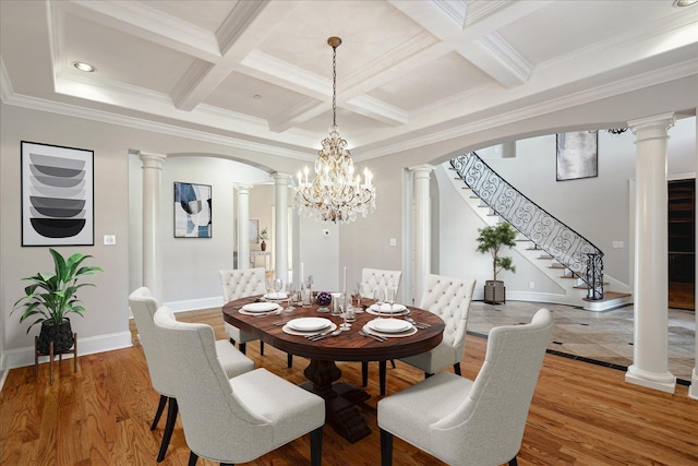 dining area featuring crown molding, beam ceiling, and ornate columns