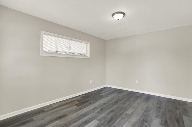 unfurnished room with dark wood-type flooring