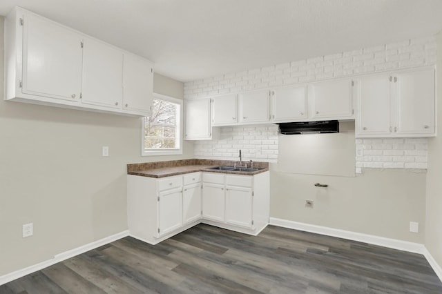 kitchen with dark wood-type flooring, sink, and white cabinets