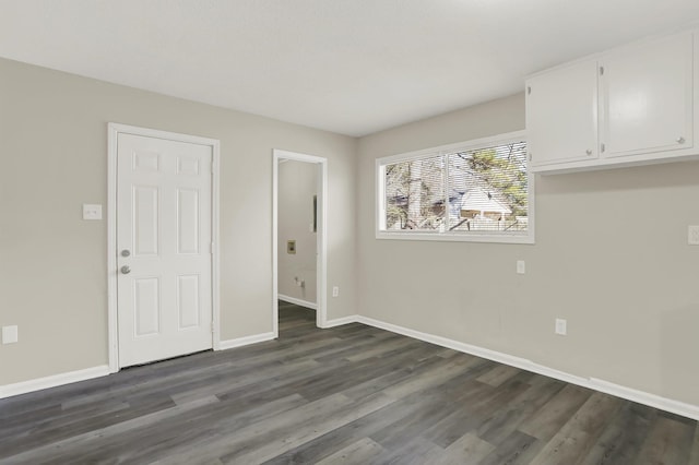 empty room featuring dark wood-type flooring