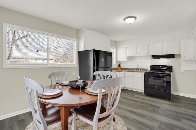 kitchen featuring sink, dark wood-type flooring, tasteful backsplash, white cabinets, and black appliances