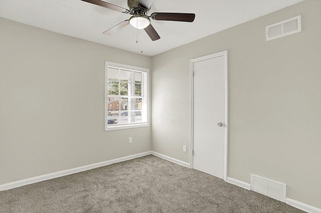 unfurnished room featuring ceiling fan and carpet