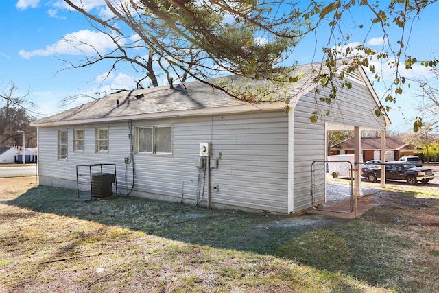 exterior space featuring central AC unit and a yard