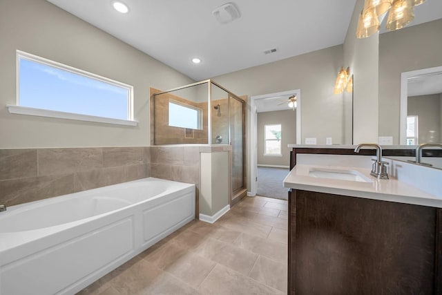 bathroom with independent shower and bath, tile patterned floors, ceiling fan, and vanity