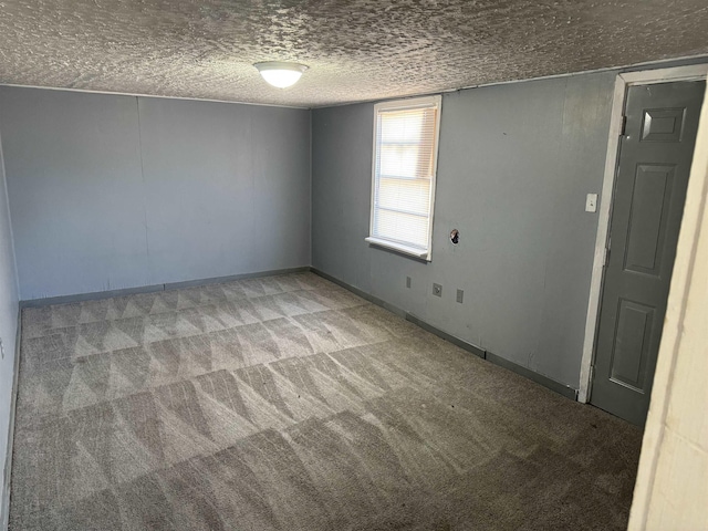 unfurnished room with a textured ceiling and carpet flooring