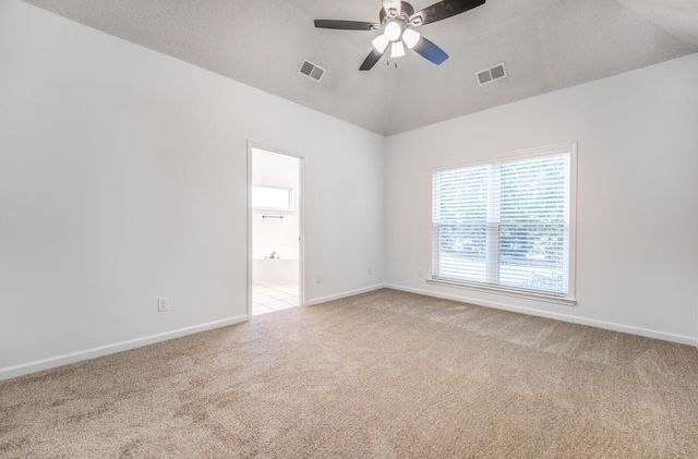 spare room featuring vaulted ceiling, ceiling fan, and carpet floors