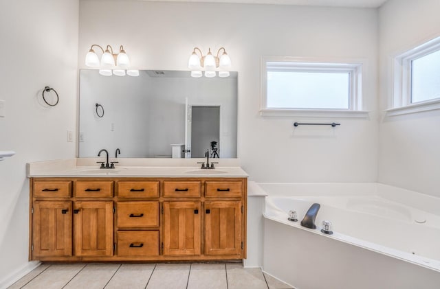 bathroom featuring a tub, tile patterned floors, and vanity